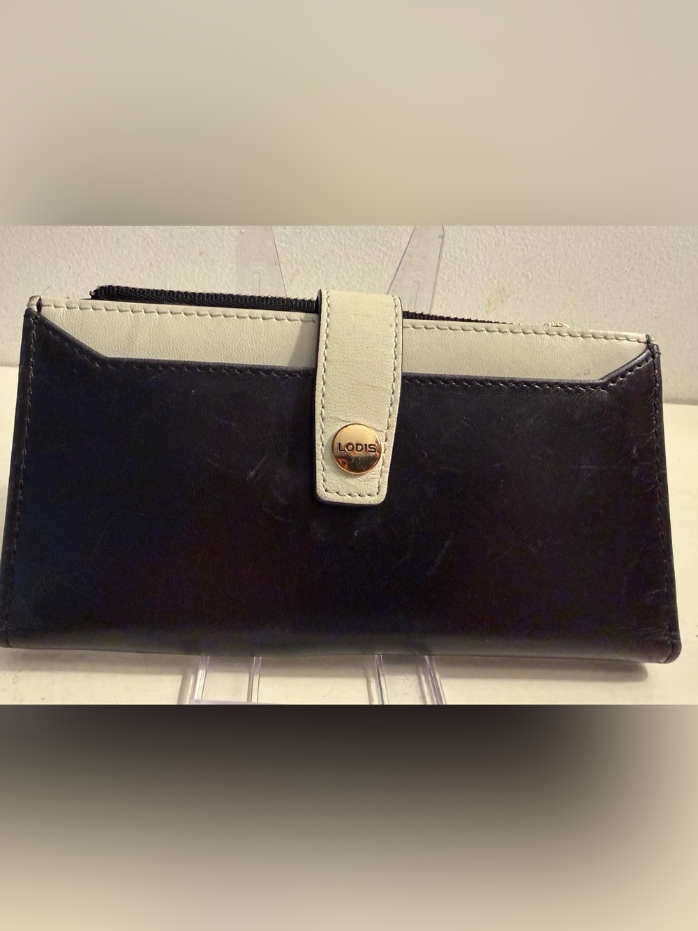 Lodis black and ivory bifold leather wallet.